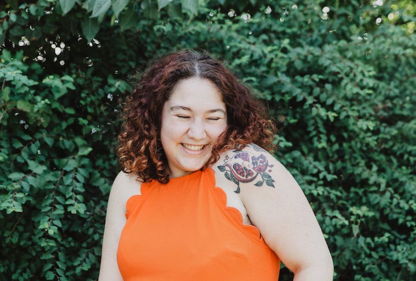 person-in-orange-shirt-with-pomegranate-tattoo.jpg